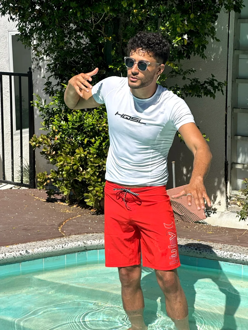 Noah Tibazi coaching a student poolside during a private swim lesson