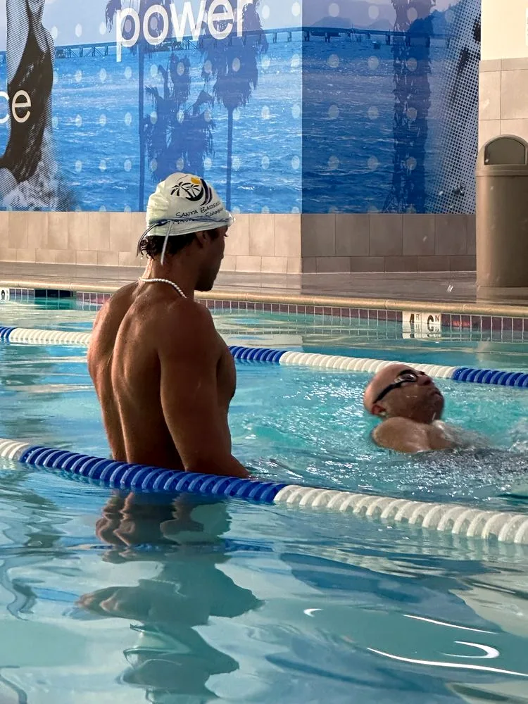 Yusuf Tibazi coaching a student during a private swim lesson